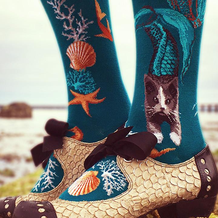Purrmaids Socks with cute cat mermaids swimming among jellyfish, seahorses & starfish in an ocean of teal. By ModSocks.