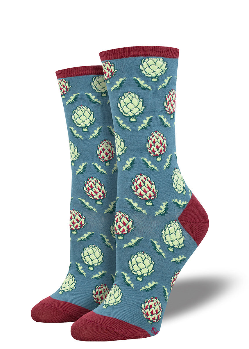 Blue crew socks for women with an allover pattern of light green artichokes and a dark red cuff, heel, and toe.