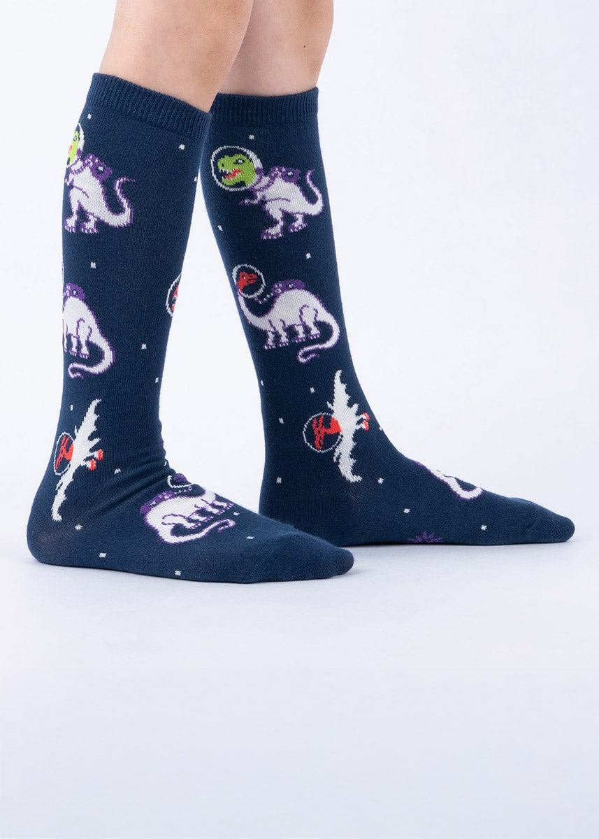 Navy knee-high kids' socks with dinosaurs-in-space design on a white background
