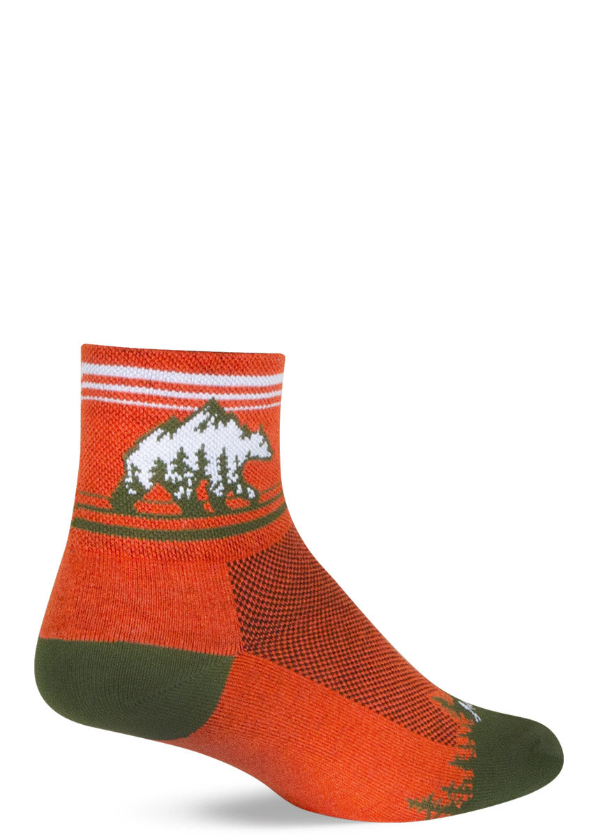 Tomato red ankle socks with an optical illusion image on the cuff that looks simultaneously like both a bear and a mountain.