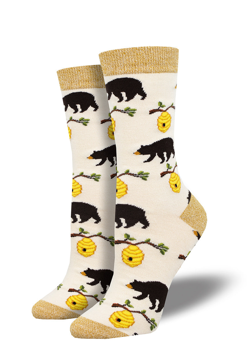 Women&#39;s bamboo crew socks with an allover repeating pattern of black bears and beehives on tree branches.