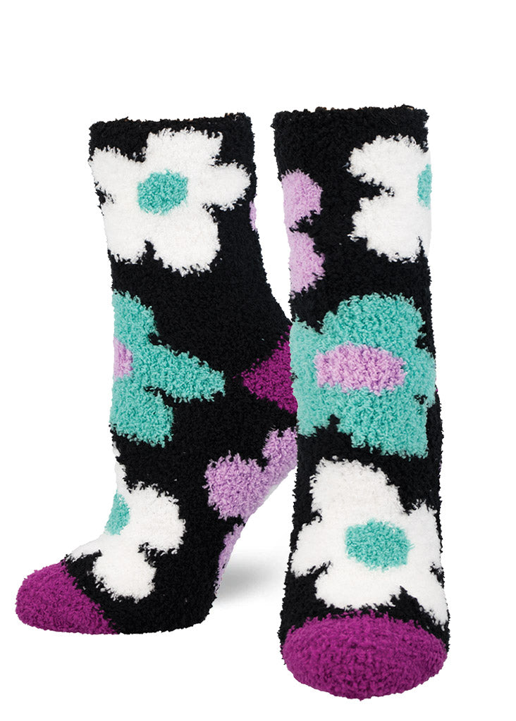 Fuzzy black floral crew socks with an allover pattern of white, teal, and purple flowers.