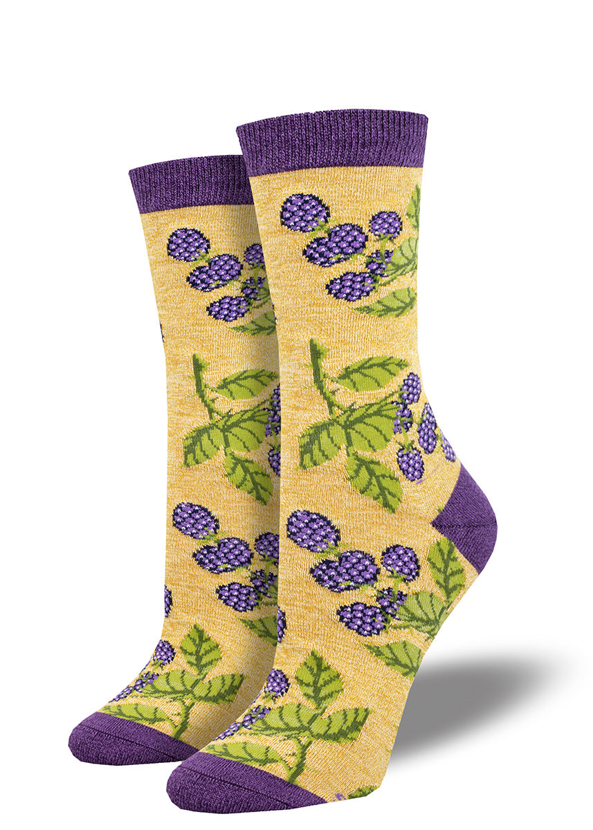 Tan crew socks feature a motif of blackberries and brambles, with dark purple accents at the heel, toe and cuff.