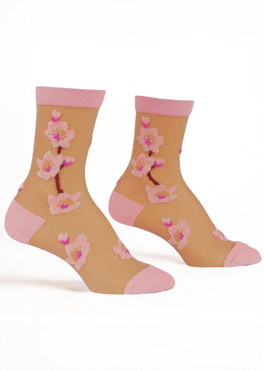 White sheer crew socks for women with light pink accents and a pink cherry blossom stem design.