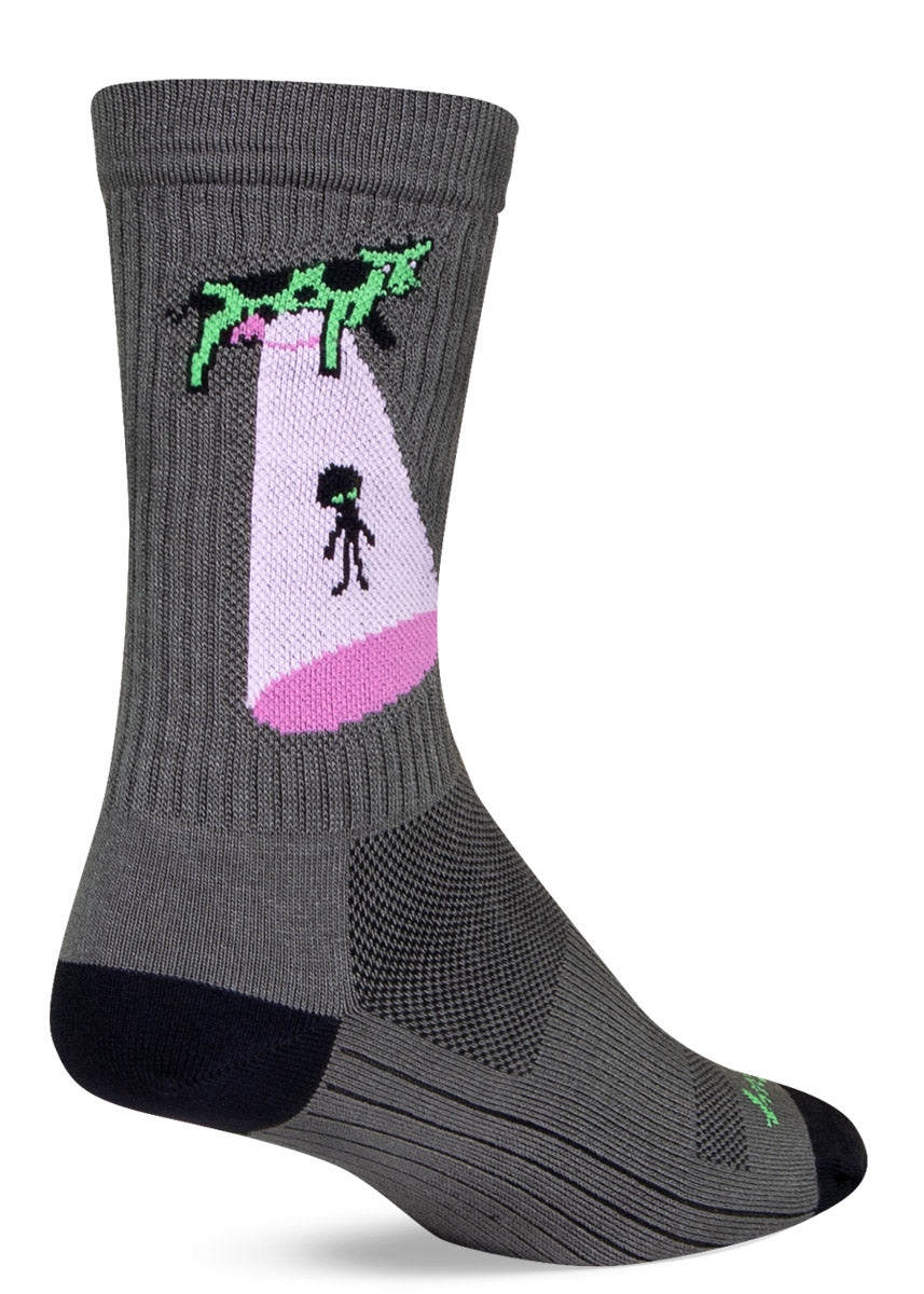 Gray crew sock with art on the leg depicting a flying cow abducting an alien.