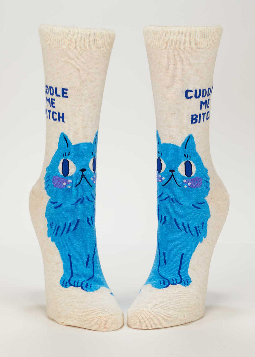 Heather cream crew socks with blue cat design and "Cuddle me, bitch" text on a white background.