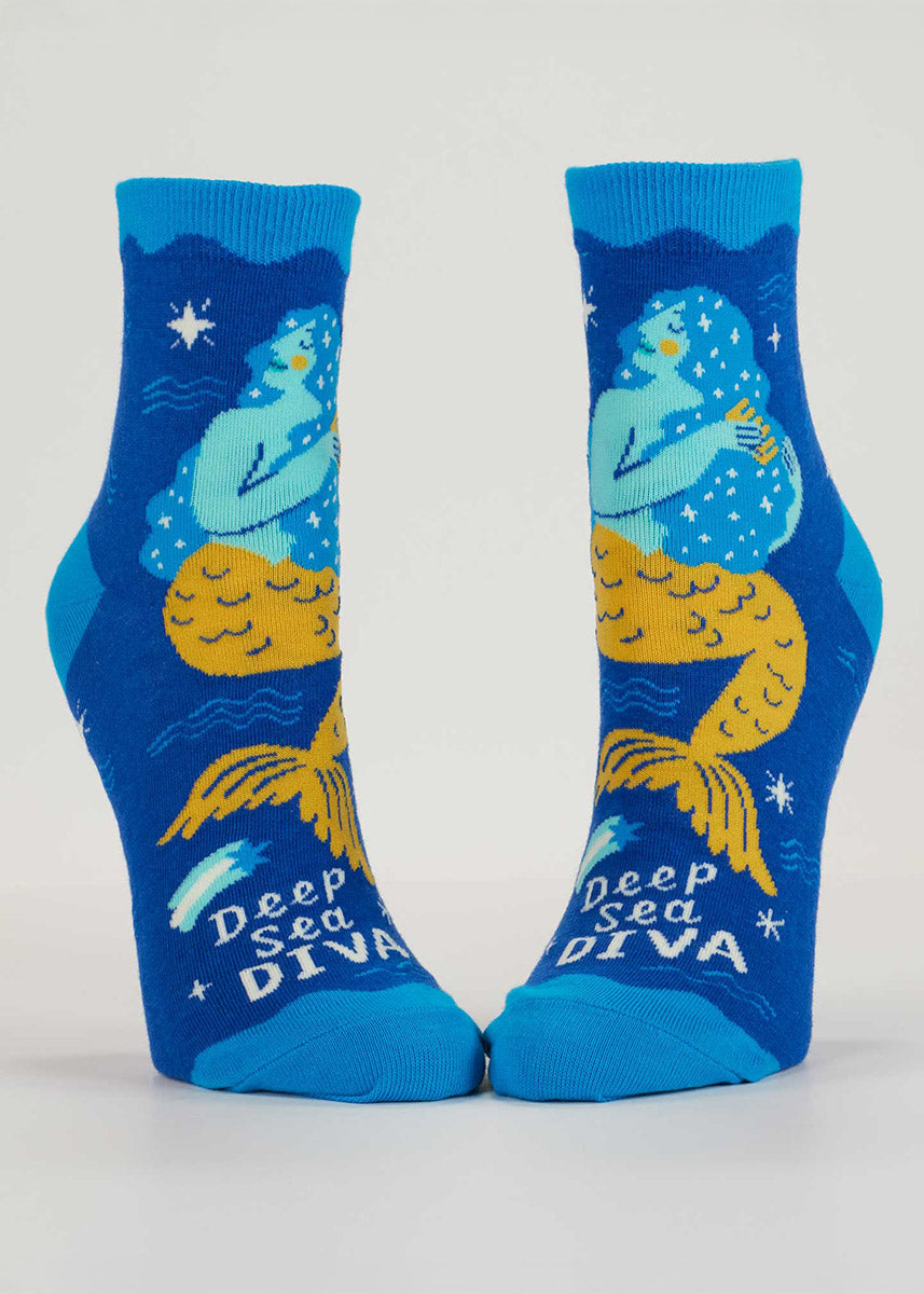 Blue ankle socks for women with a light blue and yellow mermaid combing her long hair with the words "Deep Sea Diva" written across the toe.