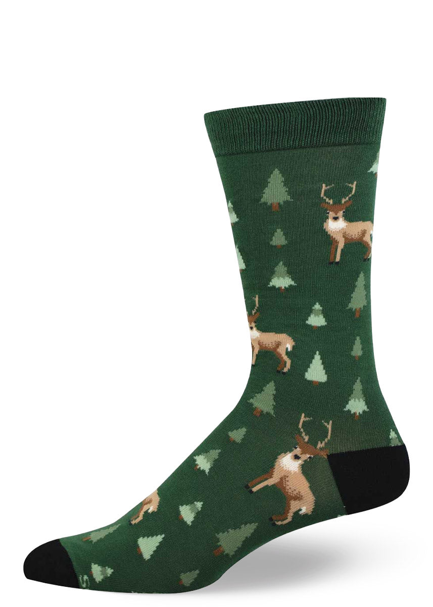 Green men's crew sock with deer and pine tree pattern on a white background.