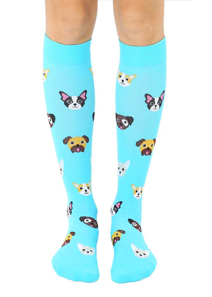 Blue knee-high compression socks with an allover pattern of various dog faces, including Boston terriers, Corgis, Chihuahuas and more.