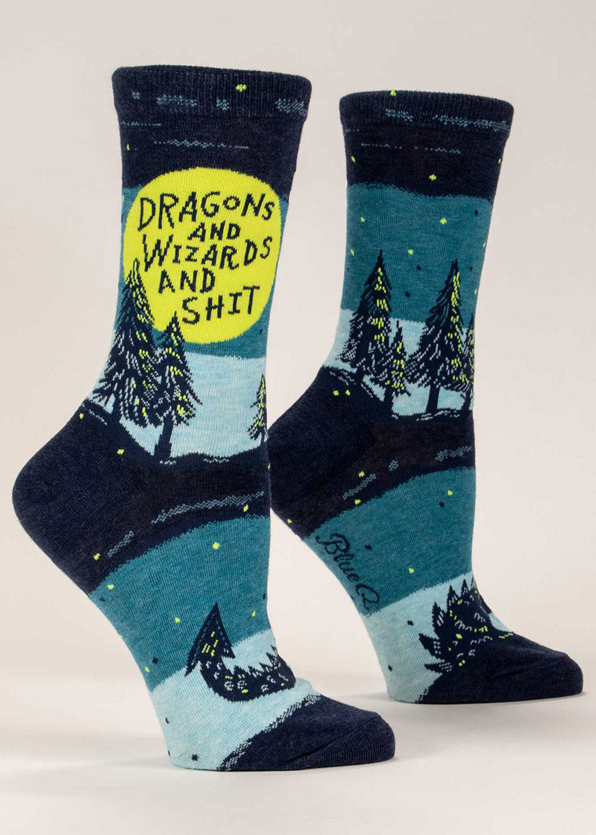 Funny fantasy socks for women show a magical forest and dragon tail with the words, "Dragons and Wizards and Shit." 