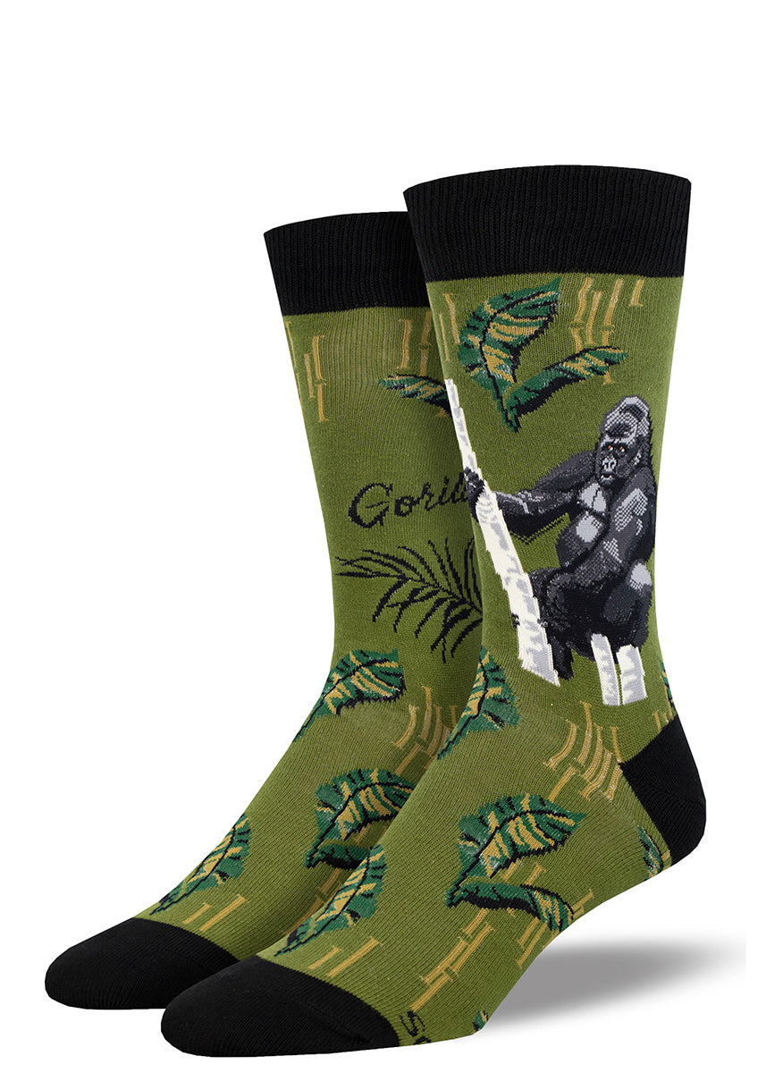 Men's crew socks featuring a design of a silverback gorilla hanging out in a tree, on a moss green background with black accents.