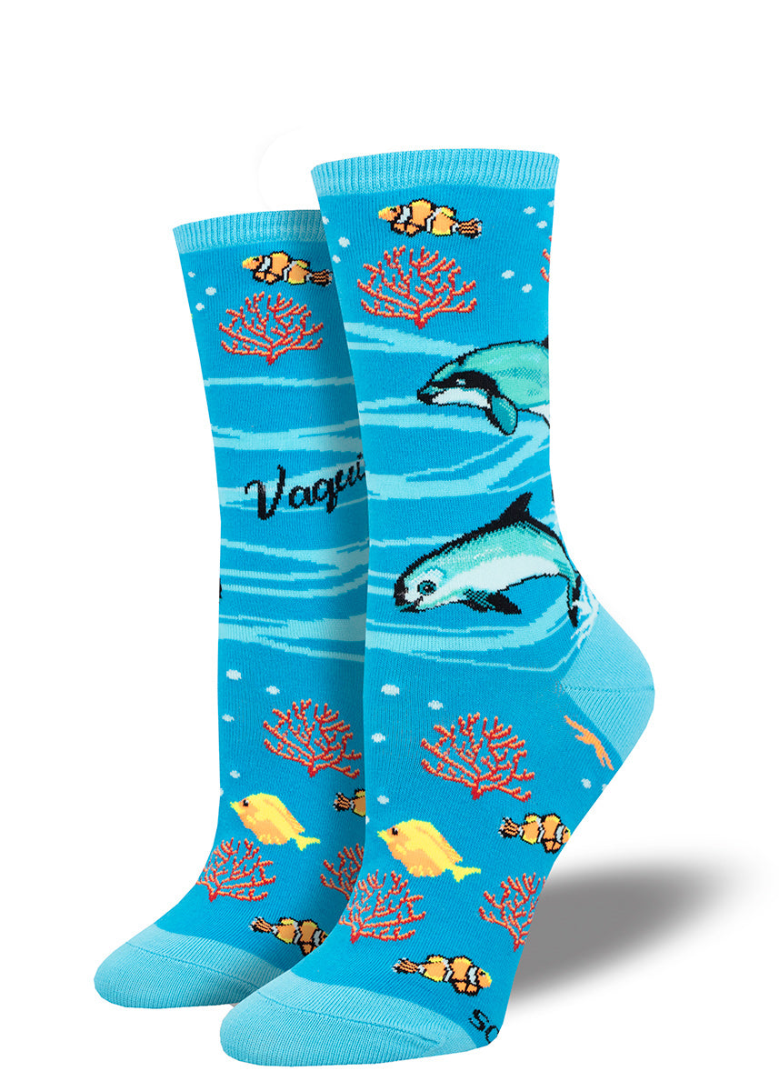 Women's crew socks featuring a design of dolphins, fish and coral on a bright blue background.