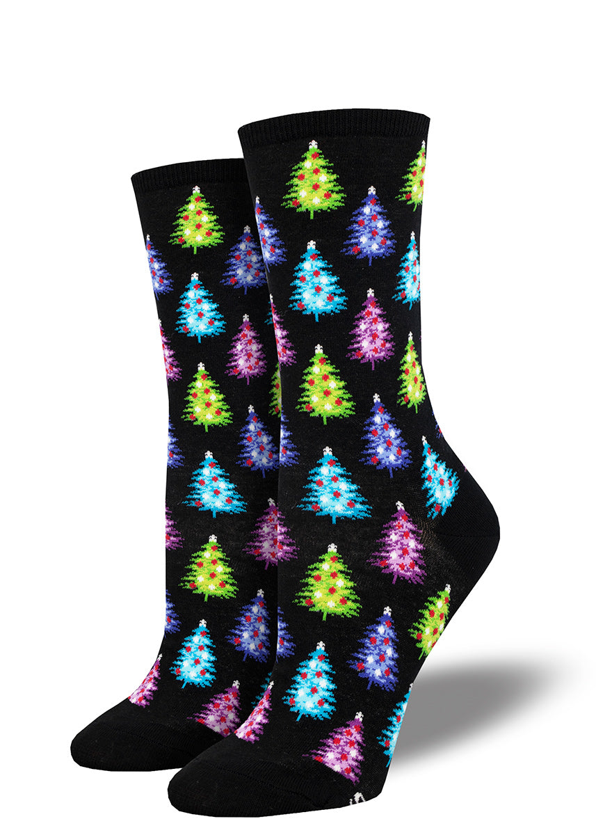 Black holiday crew socks for women with an allover pattern of Christmas trees in bright colors such as purple, blue, pink, and lime green.