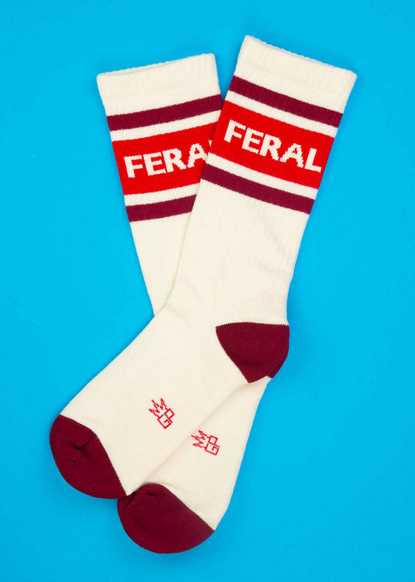 White retro gym socks with red and dark red stripes and the word "FERAL" at the cuff.