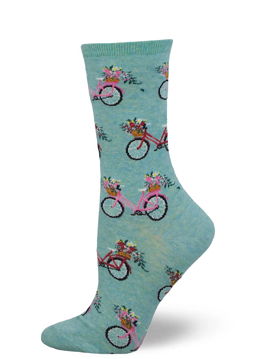 Blue crew socks for women with an allover pattern of pink and red bikes with baskets filled with flowers. 