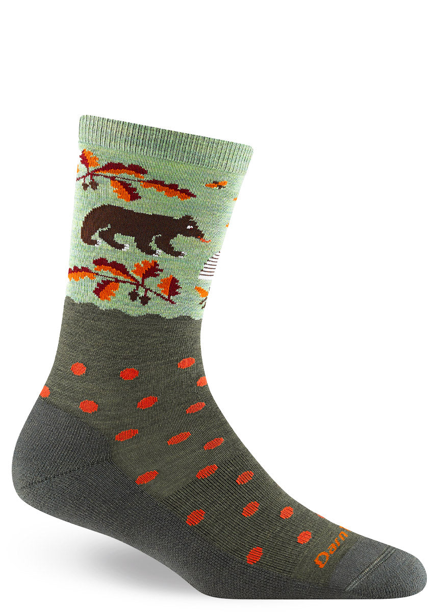 Wool crew socks with bears, beehives, orange and brown autumn foliage, plus orange polka dots on a two-toned, mossy green background.