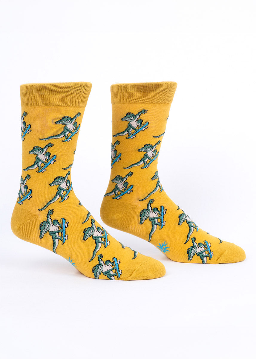 Yellow men's crew socks with allover alligator-on-a-skateboard  pattern.