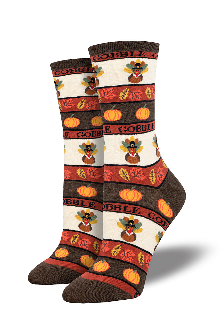 Crew socks for women with a striped brown, rust and cream Thanksgiving motif that includes turkeys, fall leaves and pumpkins.