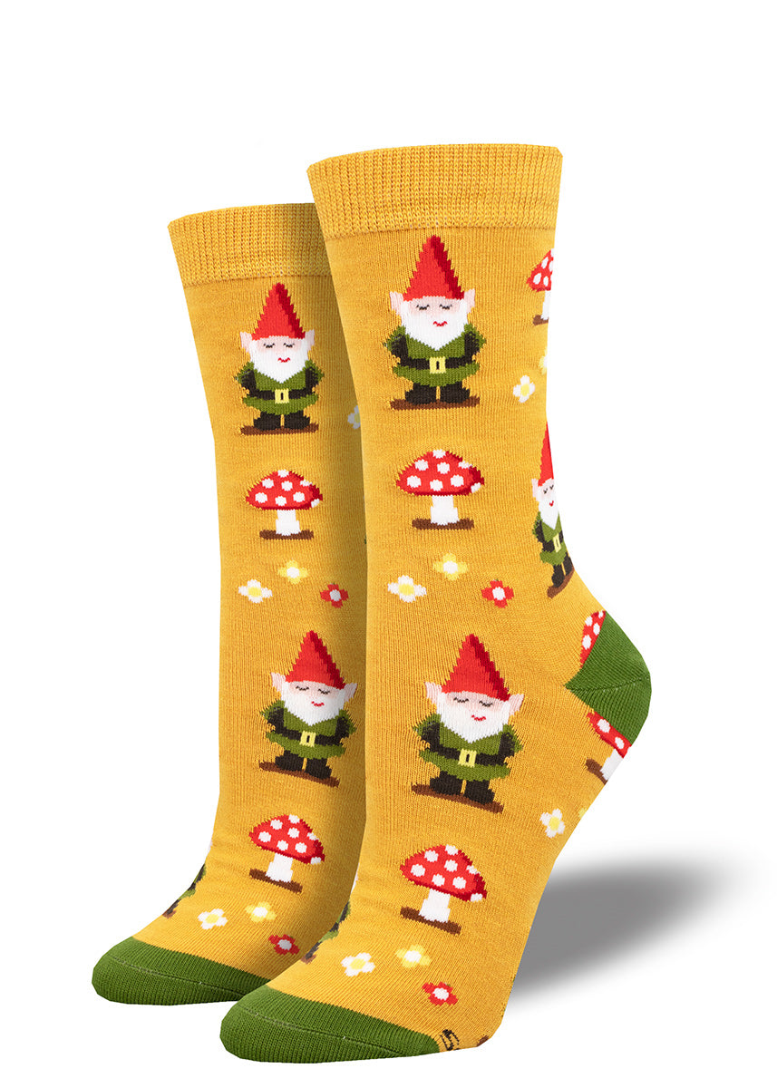 Bright gold crew socks for women with a repeating pattern of garden gnomes, flowers and red toadstools.