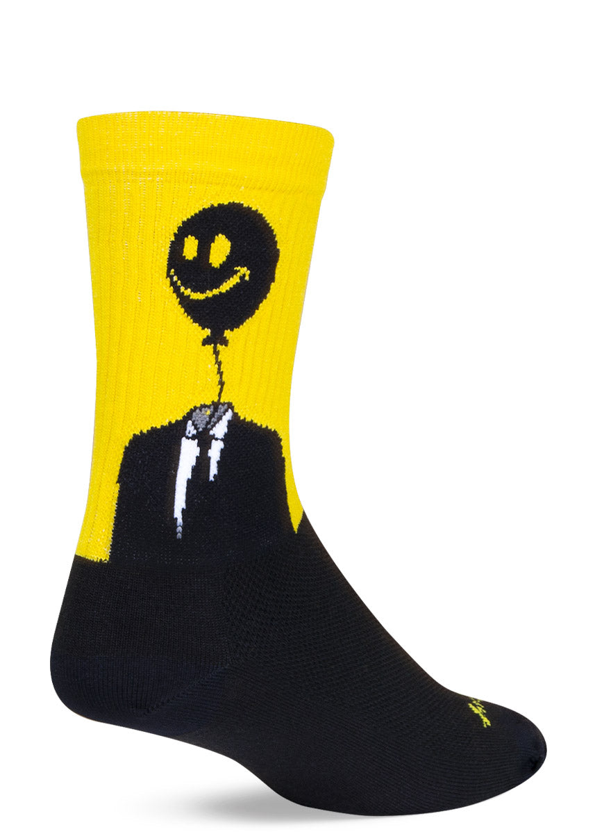 Yellow and black crew socks for men with a smiley face balloon head coming out of a men's suit and tie.
