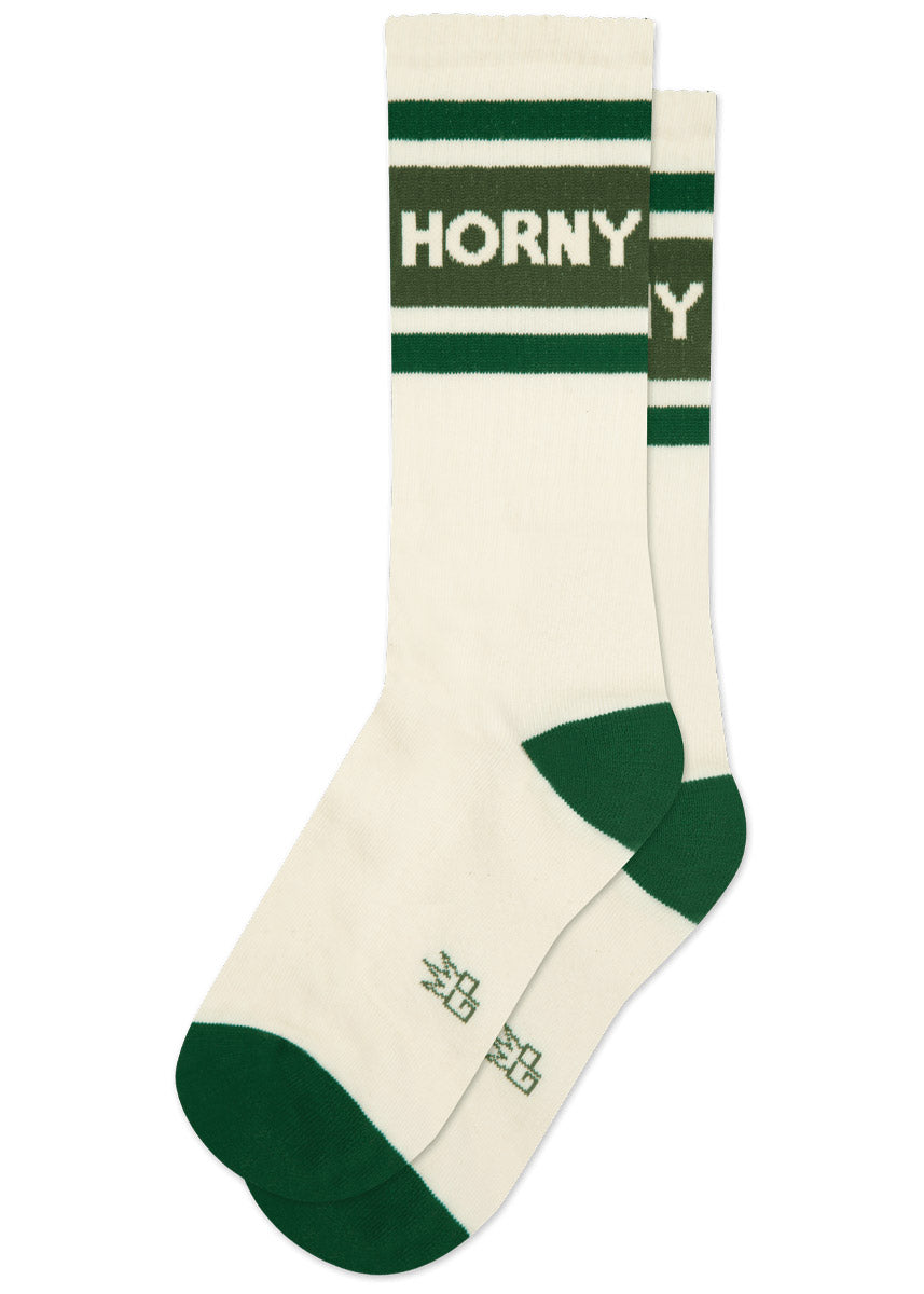White athletic crew socks with green stripes and text that says 'HORNY' on a white background.