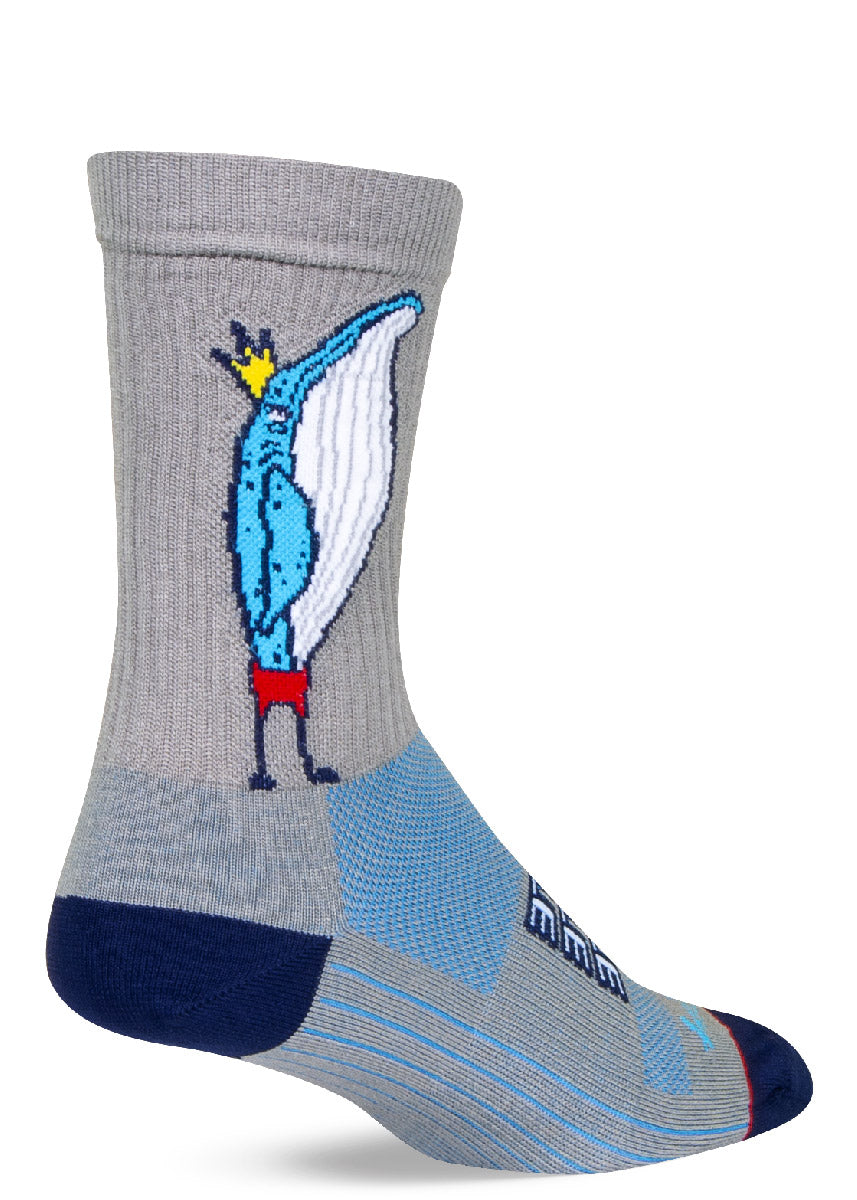 Gray athletic crew socks featuring a blue humpback whale standing upright wearing a yellow crown and red shorts.