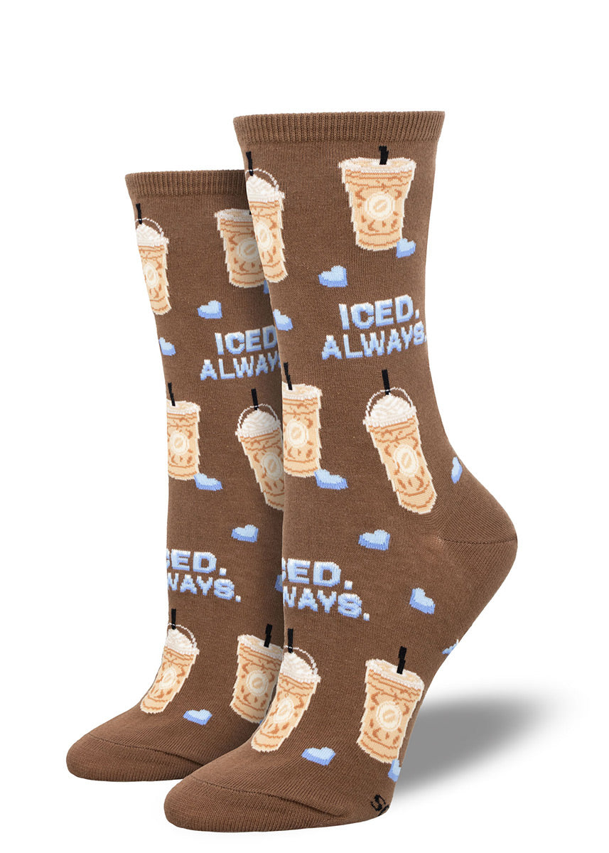 Brown crew socks for women with a repeating pattern of iced coffee drinks, small pieces of ice shaped like hearts, and the words "ICED ALWAYS" in blue letters.