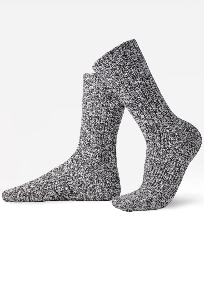 Black and white slouch crew socks with a ribbed slub-knit texture and mottled, heathered coloring.