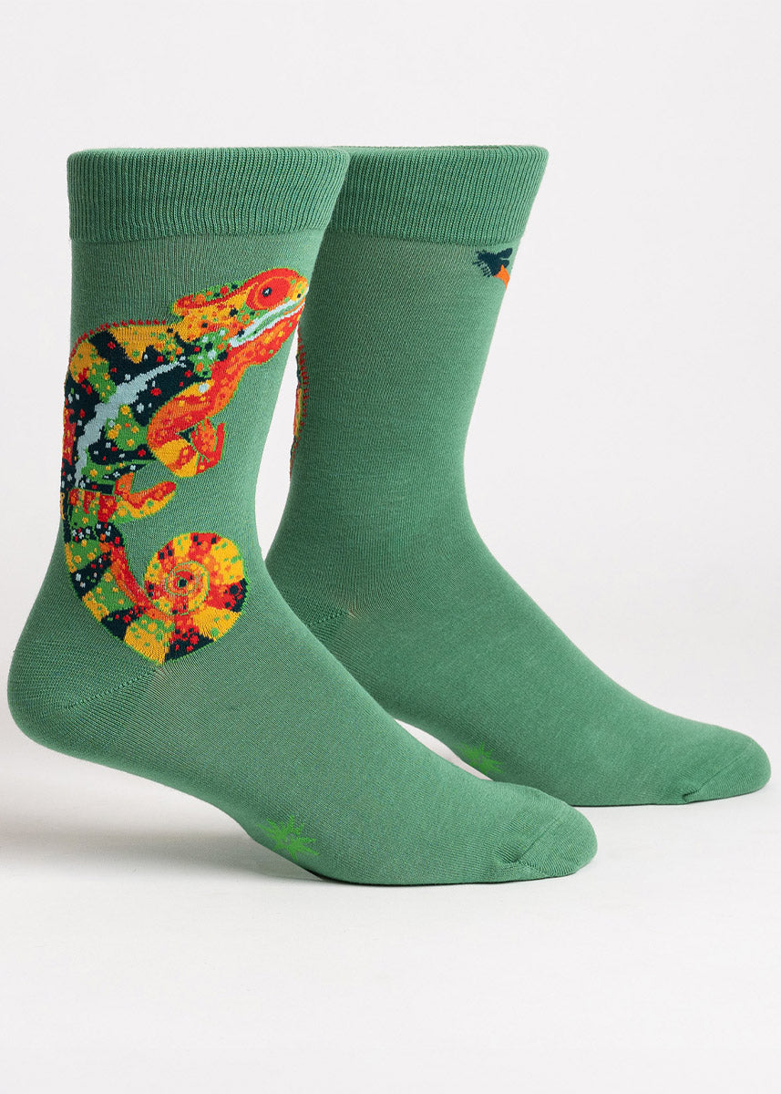 Green crew socks for men that feature a large chameleon sticking its tongue out to catch a fly in bright vibrant colors of reds, oranges, yellows, and greens.