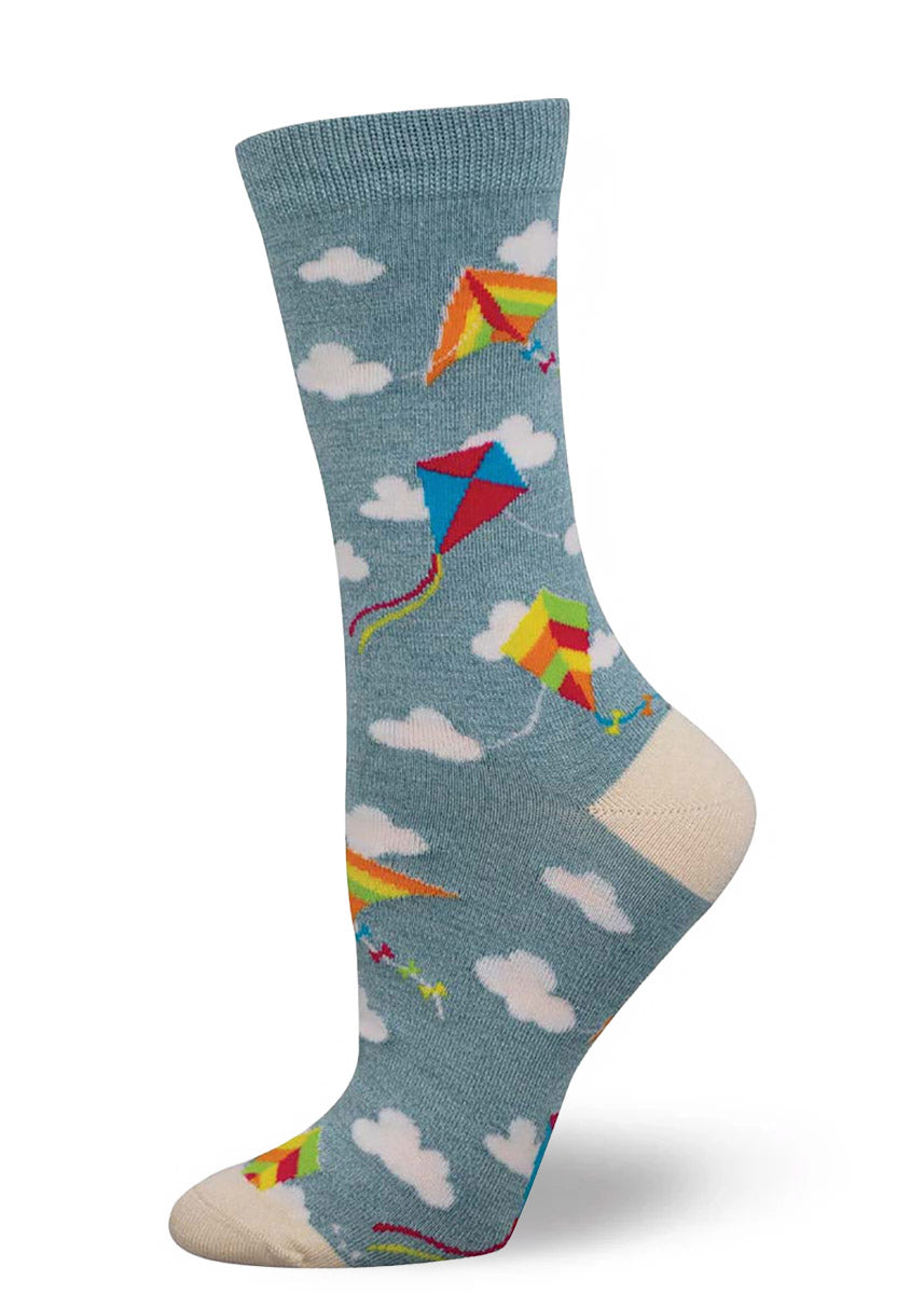 Light blue crew socks for women with an allover pattern of white clouds and colorful kites. 
