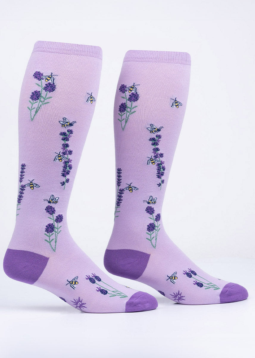 Light purple knee-high socks covered in lavender flowers with bees buzzing around their blossoms.