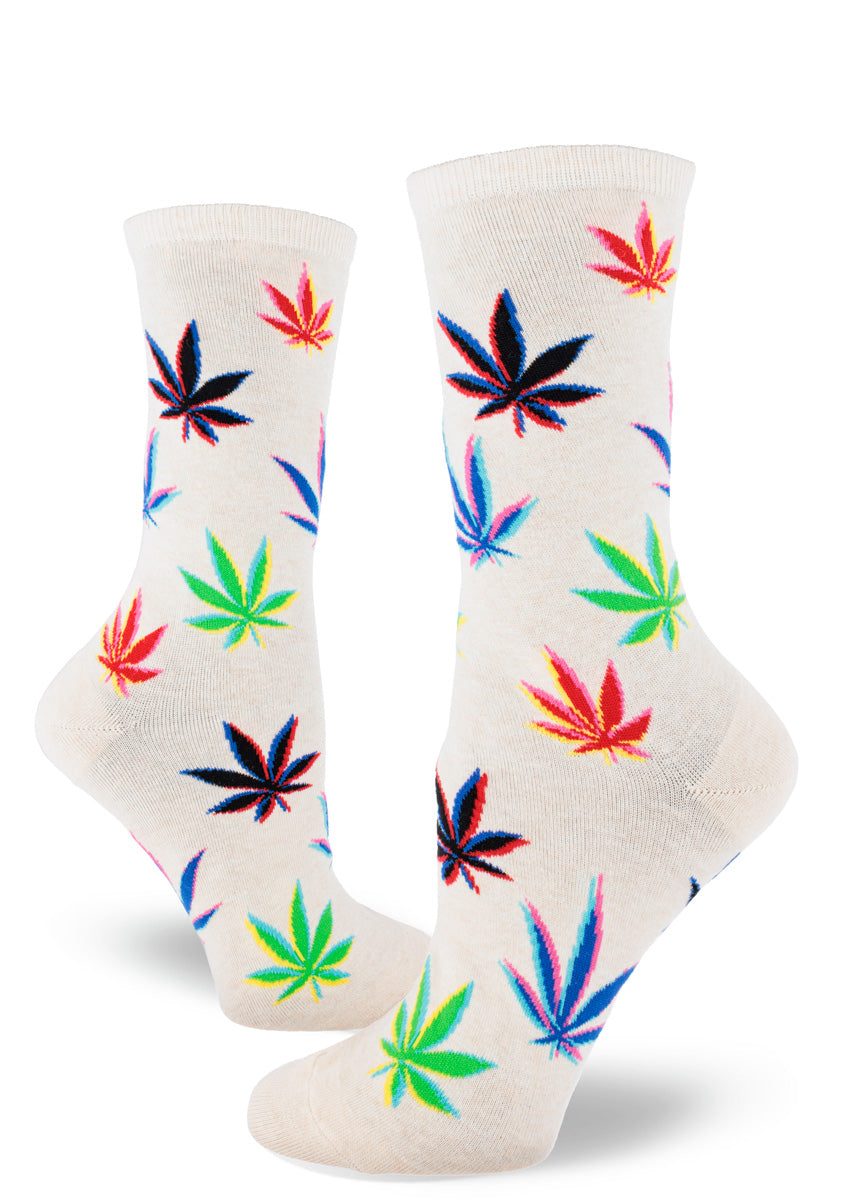 Women&#39;s crew socks feature colorful pot leaves with an artistic glitch effect against a heather cream background.