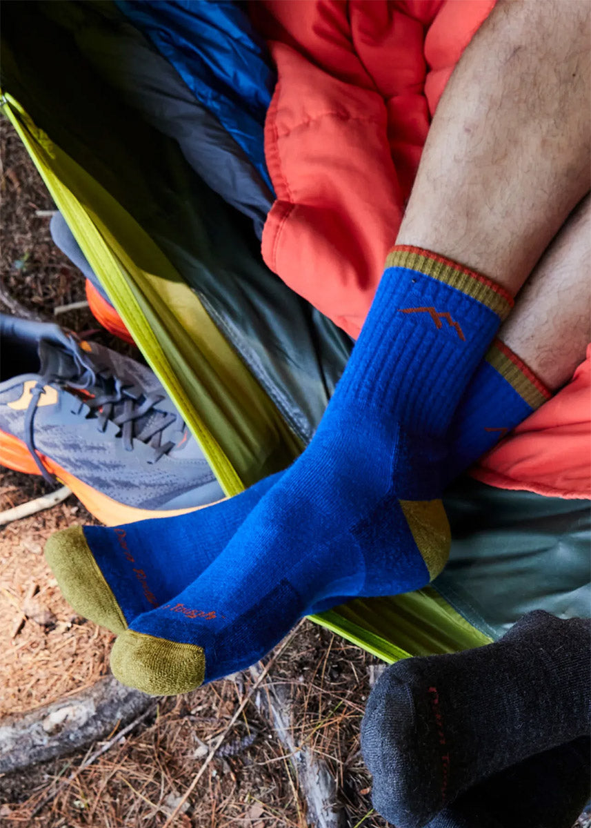 Blue hiking socks for men in crew length with a gold cuff, heel, and toe.