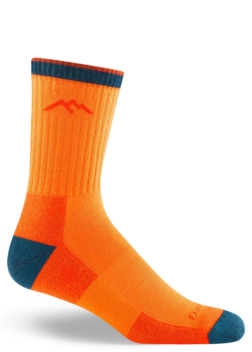 Orange hiking socks for men in crew length with a dark teal cuff, heel, and toe. 