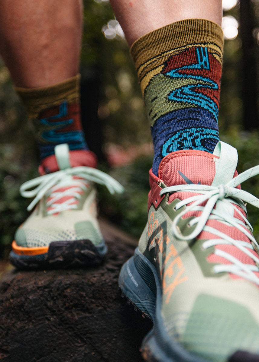 Dark blue, rust, and mustard yellow lightweight wool hiking socks for men with a waterfall landscape design.
