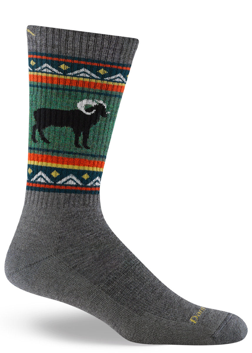 Cushioned wool hiking socks for men feature a black ram over a bold green and gray background with orange accents.