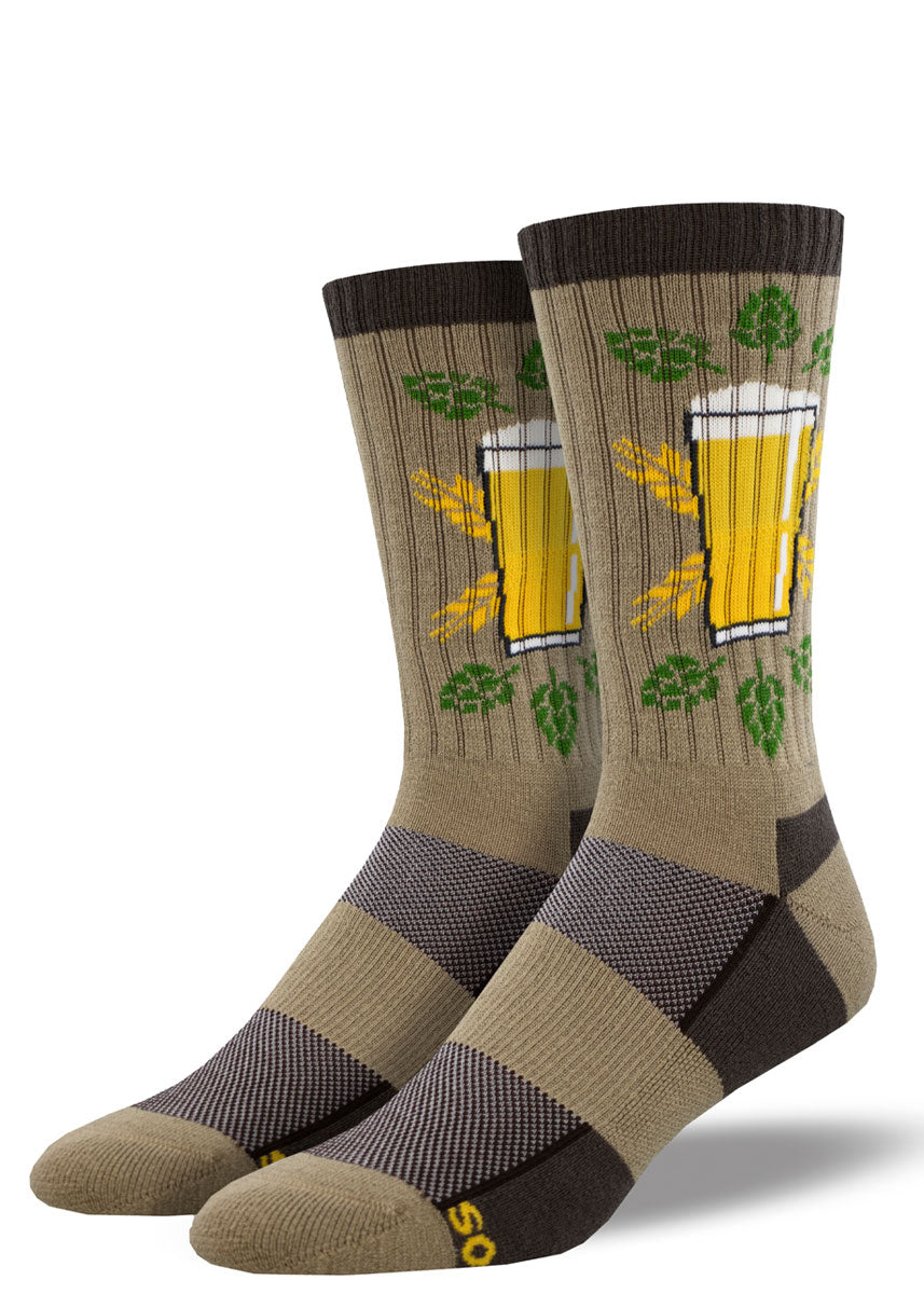 Light brown, yellow, and dark brown wool hiking socks for men featuring a pint of beer with a design of green hops encircling it.
