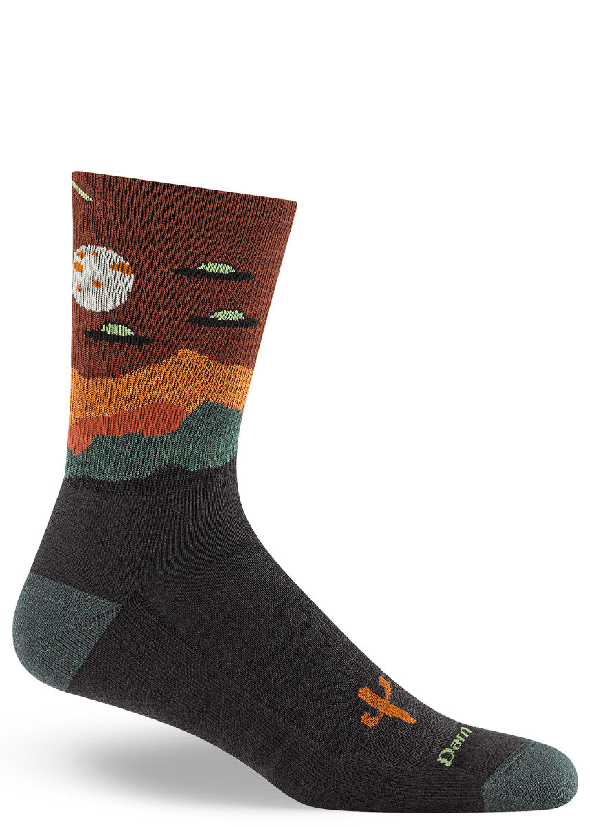 Men's crew sock with a design of flying saucer UFOs looming over the desert on a moonlit night.