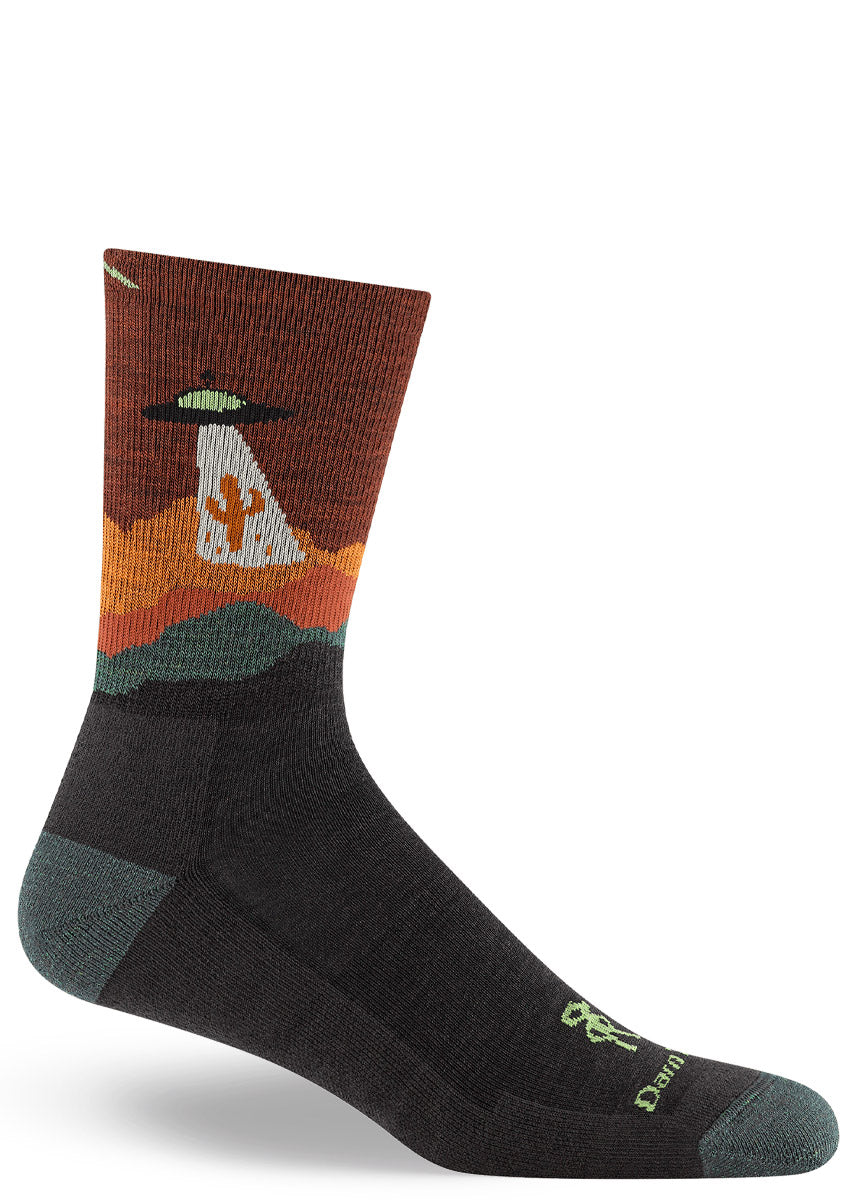 Men's crew sock with a design depicting a flying saucer UFO abducting a cactus from the desert.