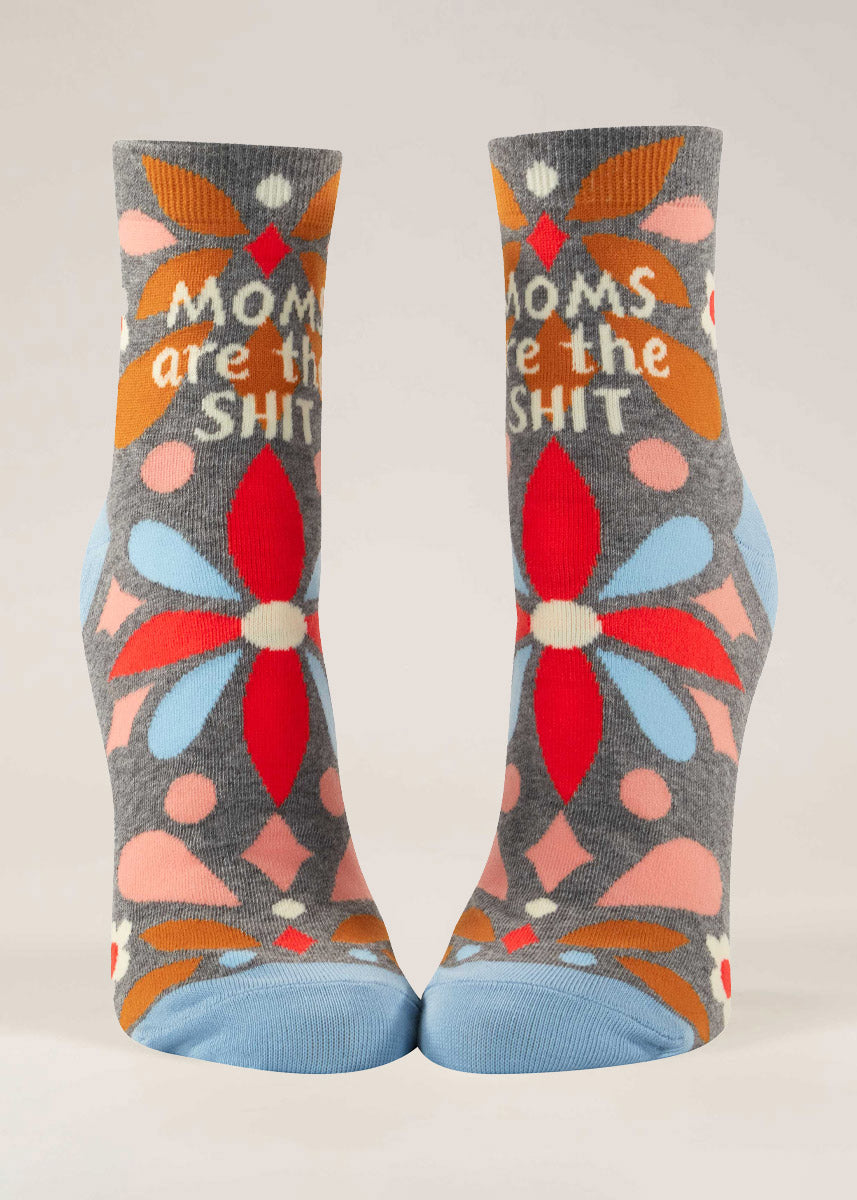 Light gray ankle socks for women featuring a colorful flower design as well as the phrase "Moms Are the Shit." 