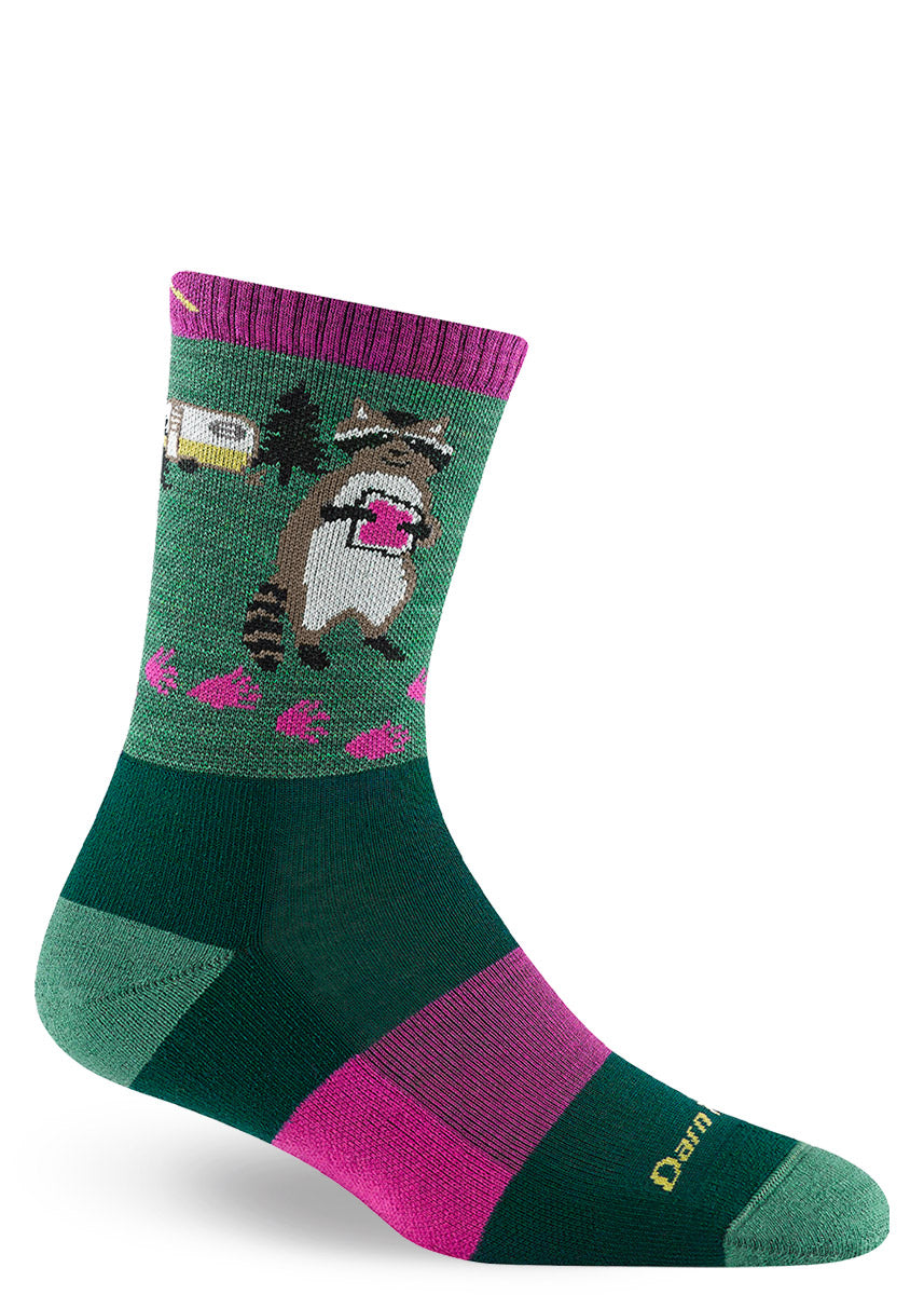 Green and pink striped hiking socks for women show a trail of pink footprints leading from a camper van to a raccoon holding a pink jam sandwich.