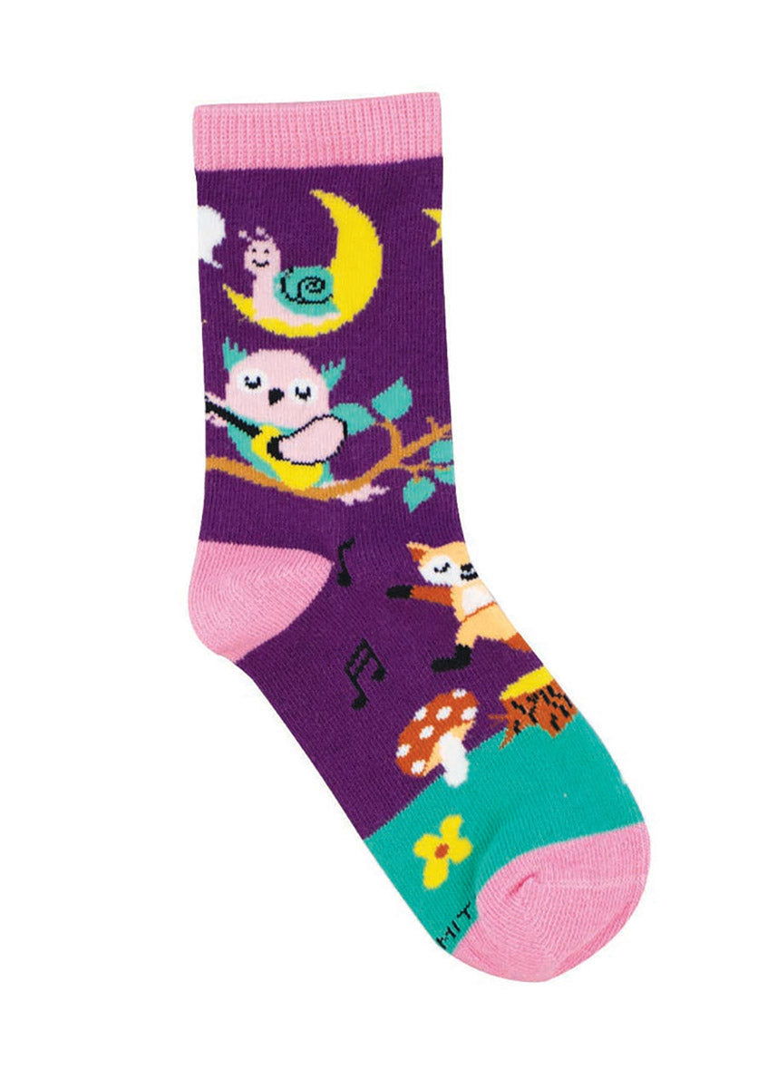Purple crew socks for kids featuring a woodland scene of an owl playing guitar, a fox dancing to the music, and a snail resting atop a crescent moon.