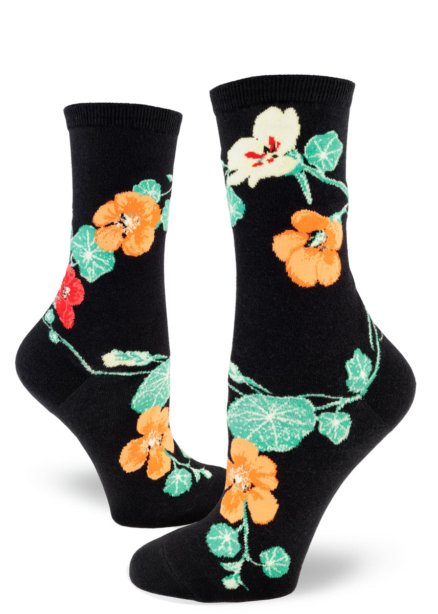 Crew socks for women with yellow, orange and red nasturtium flowers on a black background.