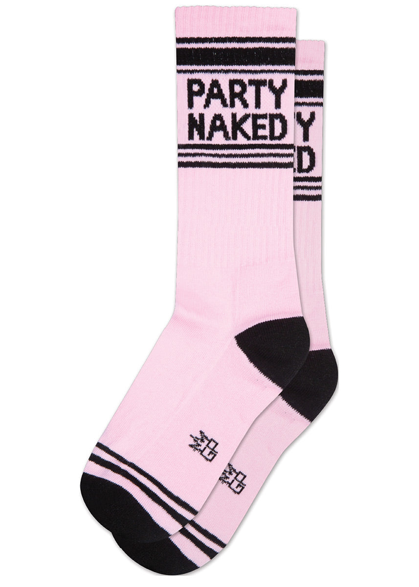Retro athletic-style crew socks have the words “PARTY NAKED” on a light pink background with stripes in black.