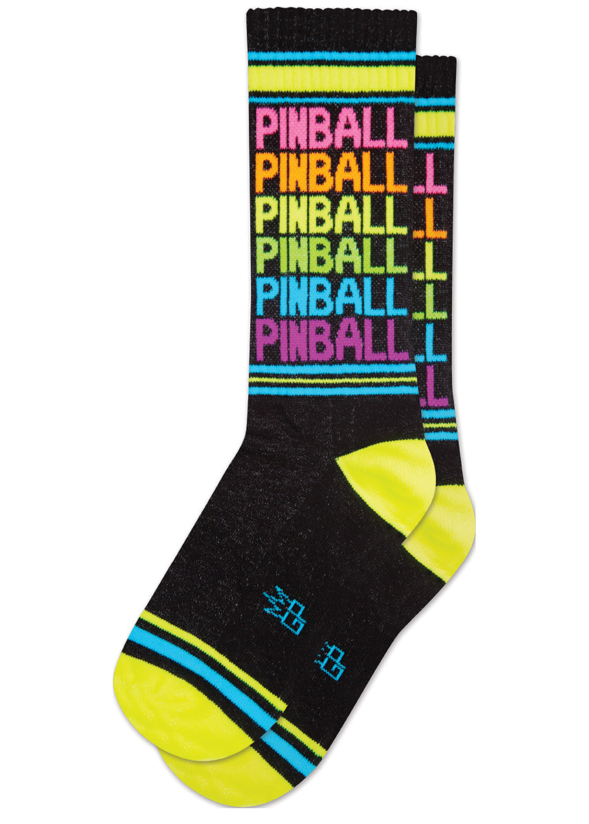 Black retro-style striped gym socks repeat “PINBALL” six times in neon rainbow lettering, accented with colorful neon stripes and highlighter yellow neon at the heel and toe.
