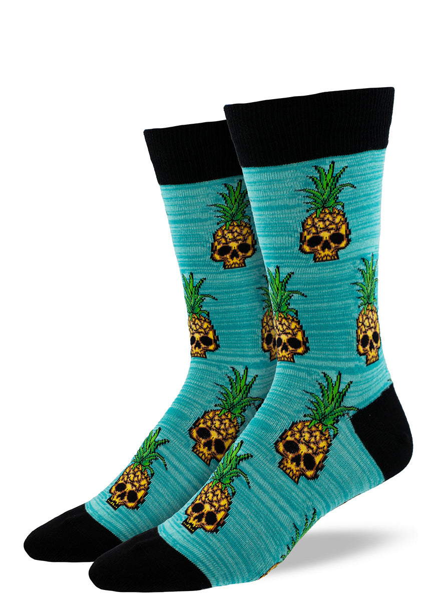 Blue crew socks for men with a repeating pattern of yellow pineapples in the shape of skulls.