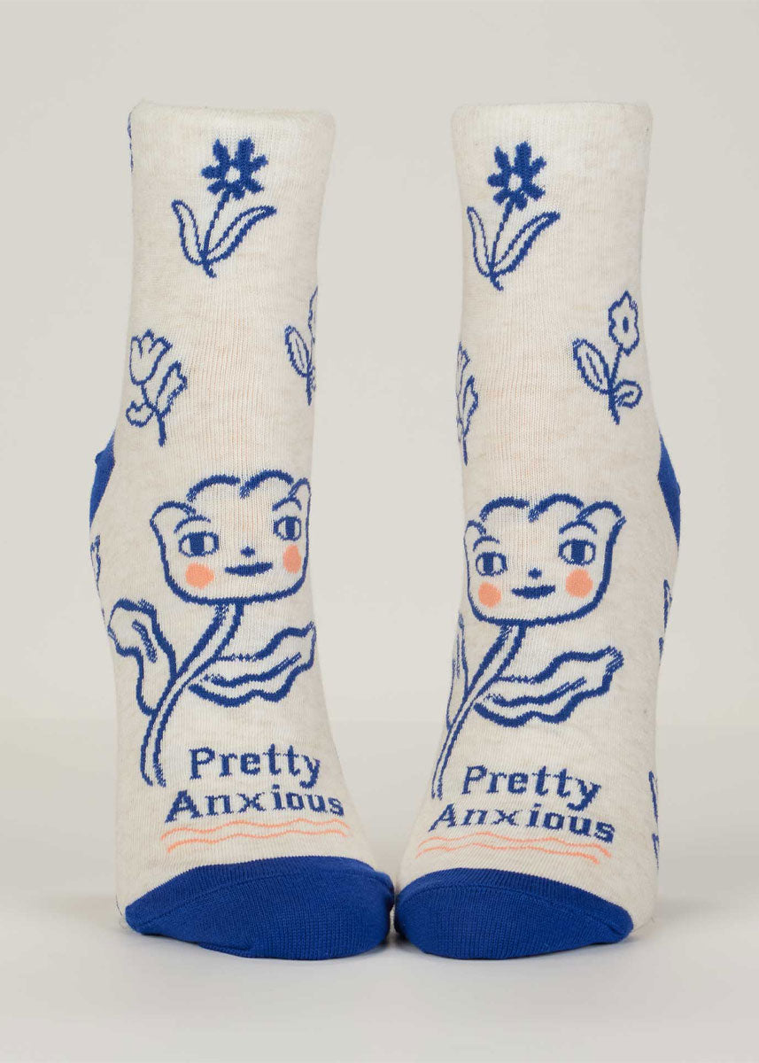 White ankle socks for women with a dark blue floral pattern, including a tulip with a blushing face and the words "Pretty Anxious."