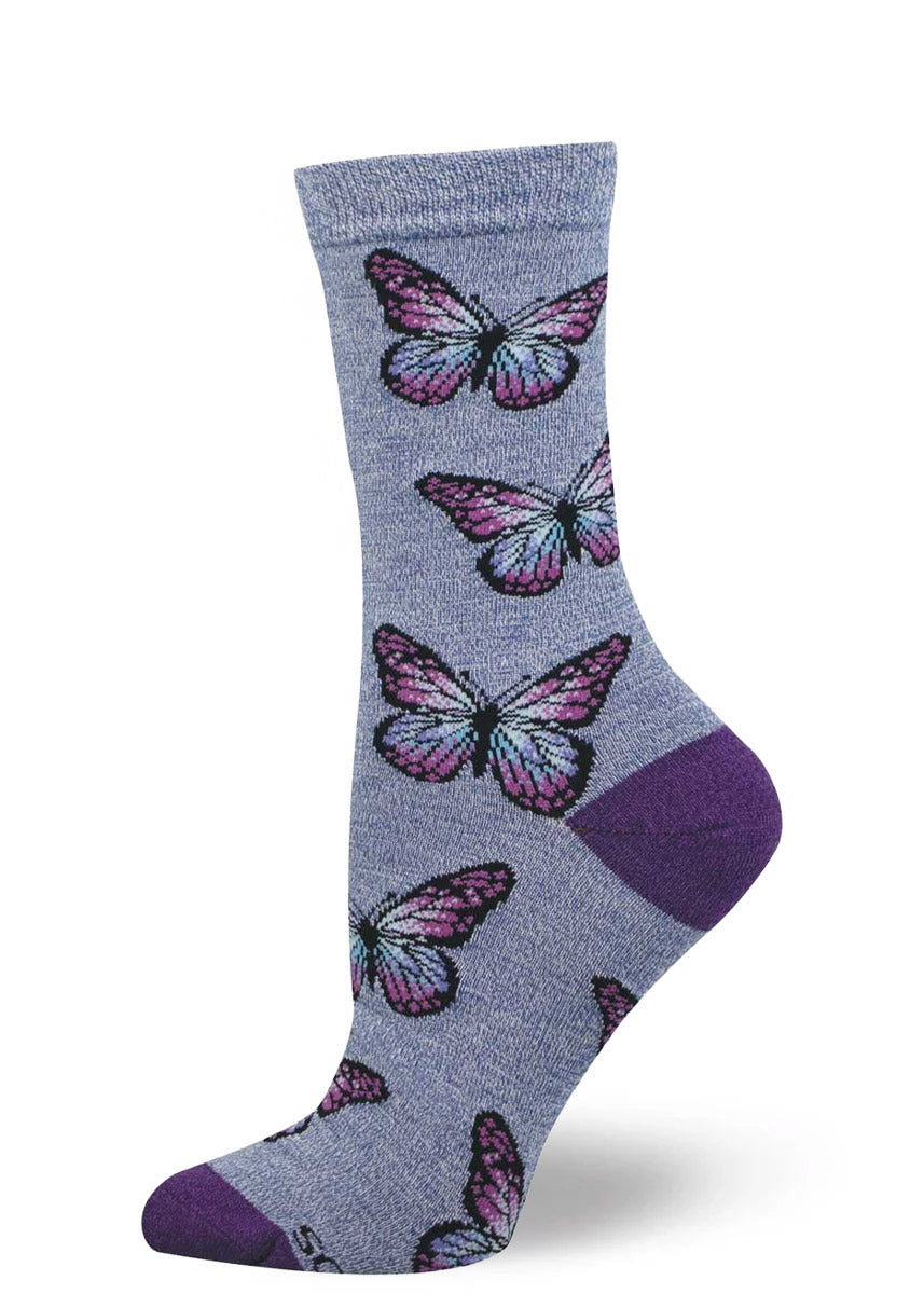 Purple crew socks for women with an allover pattern of purple, pink, and blue butterflies.