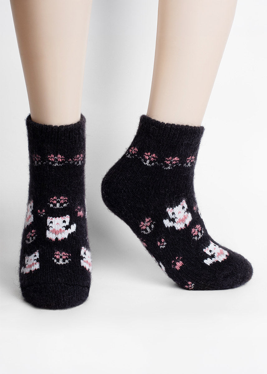 Thick, fuzzy black merino quarter socks with a design of white kittens and pink flowers.