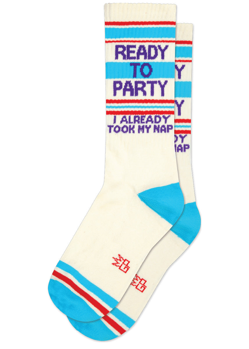 Cream retro-styled gym socks have blue and red stripes and say "READY TO PARTY," then in smaller letters, "I ALREADY TOOK MY NAP" in purple lettering.